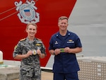 Coast Guard Capt. Matthew Rooney, the commanding officer of the Coast Guard Cutter Midgett (WMSL 757) and Royal Australian Navy Capt. Rebecca Levitt, the commanding officer of His Majesty’s Australian Ship Kuttabul, exchange patches during a media engagement in Sydney, Feb. 25, 2025. In the spirit of Pacific Quadrilateral Defense Coordinating Group, the Coast Guard continues its vital collaboration with Australian law enforcement to identify maritime vulnerabilities and cooperate on solutions to reduce risk to safety, health, and security throughout Oceania. (U.S. Coast Guard photo by Petty Officer 3rd Class Jennifer Nilson)