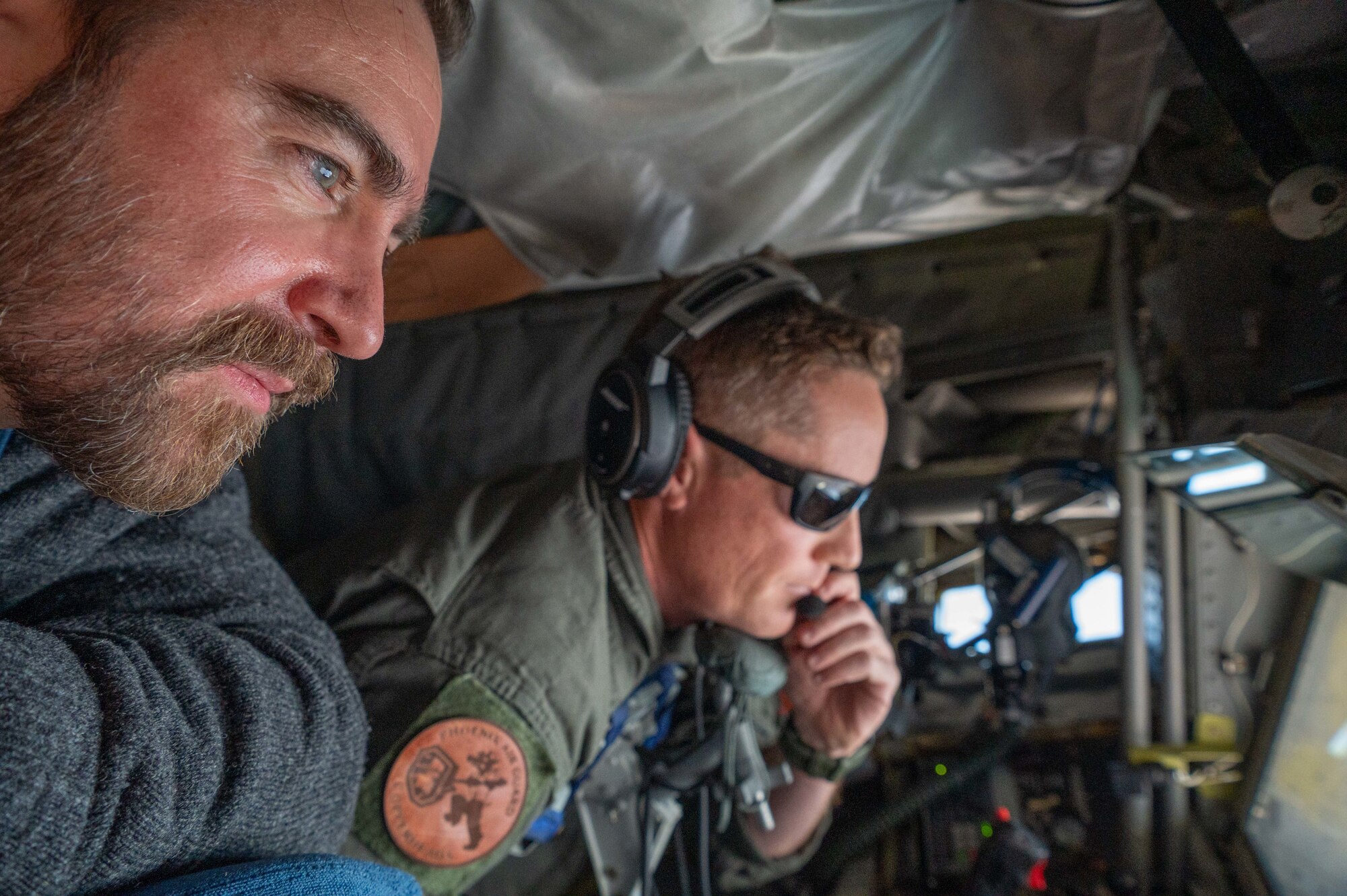 Arizona Air National Guard Master Sgt. Nick Savasta, 161st Air Refueling Wing boom operator, explains the complex refueling process to a 944th Fighter Wing Honorary Commander during a flight from Goldwater Air National Guard Base, Ariz., Nov. 8, 2024. During the flight civic leaders observed the coordinated efforts needed to fuel aircraft midair, gaining an appreciation for the mission's intricacies. (U.S. Air Force photo by Senior Airman Alexis Orozco)
