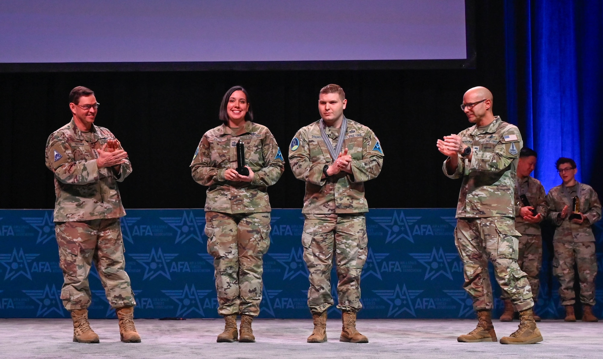 A group of military members receive awards.