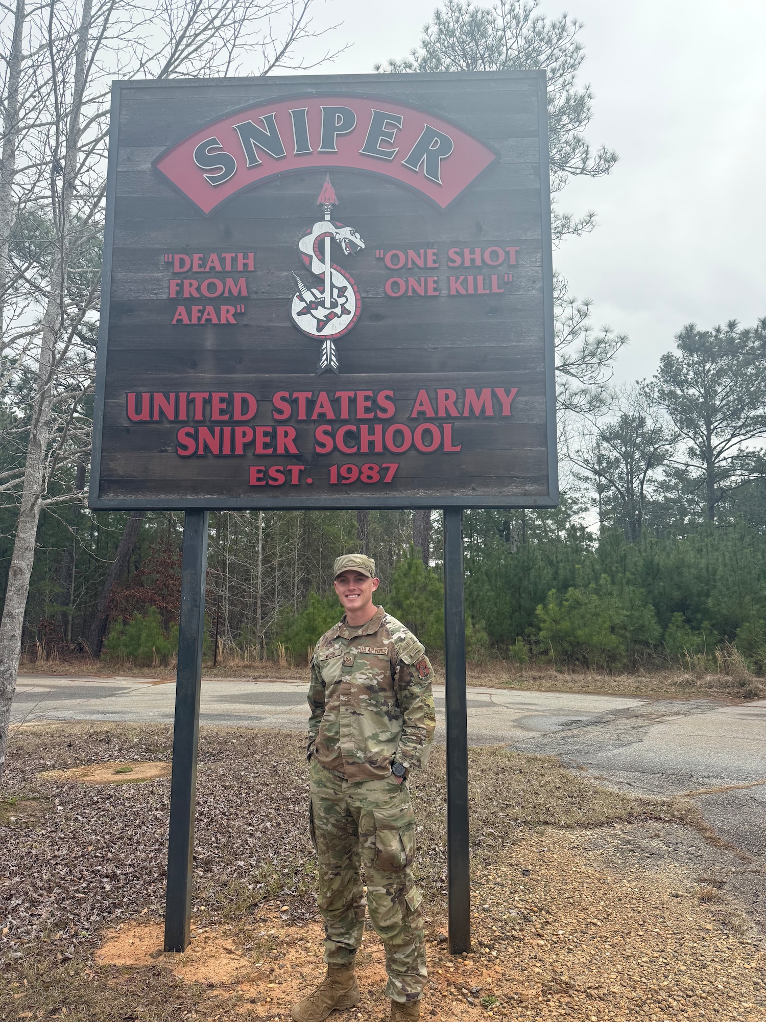 a man stands in front of a sign