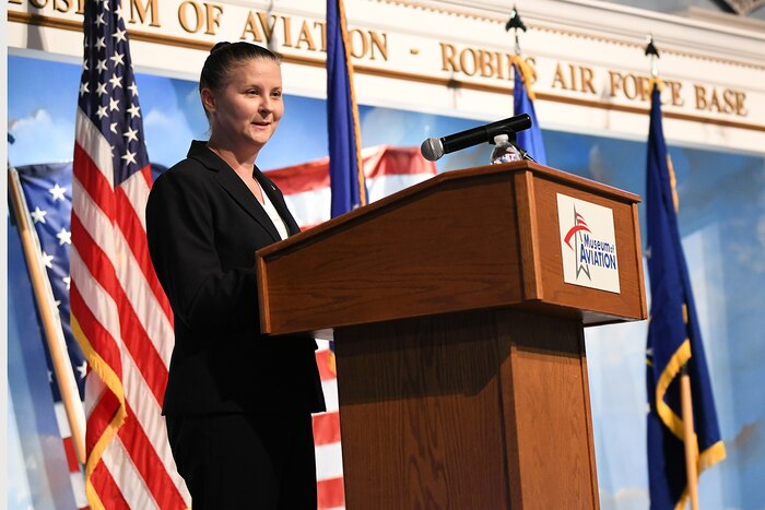 woman speaking behind podium