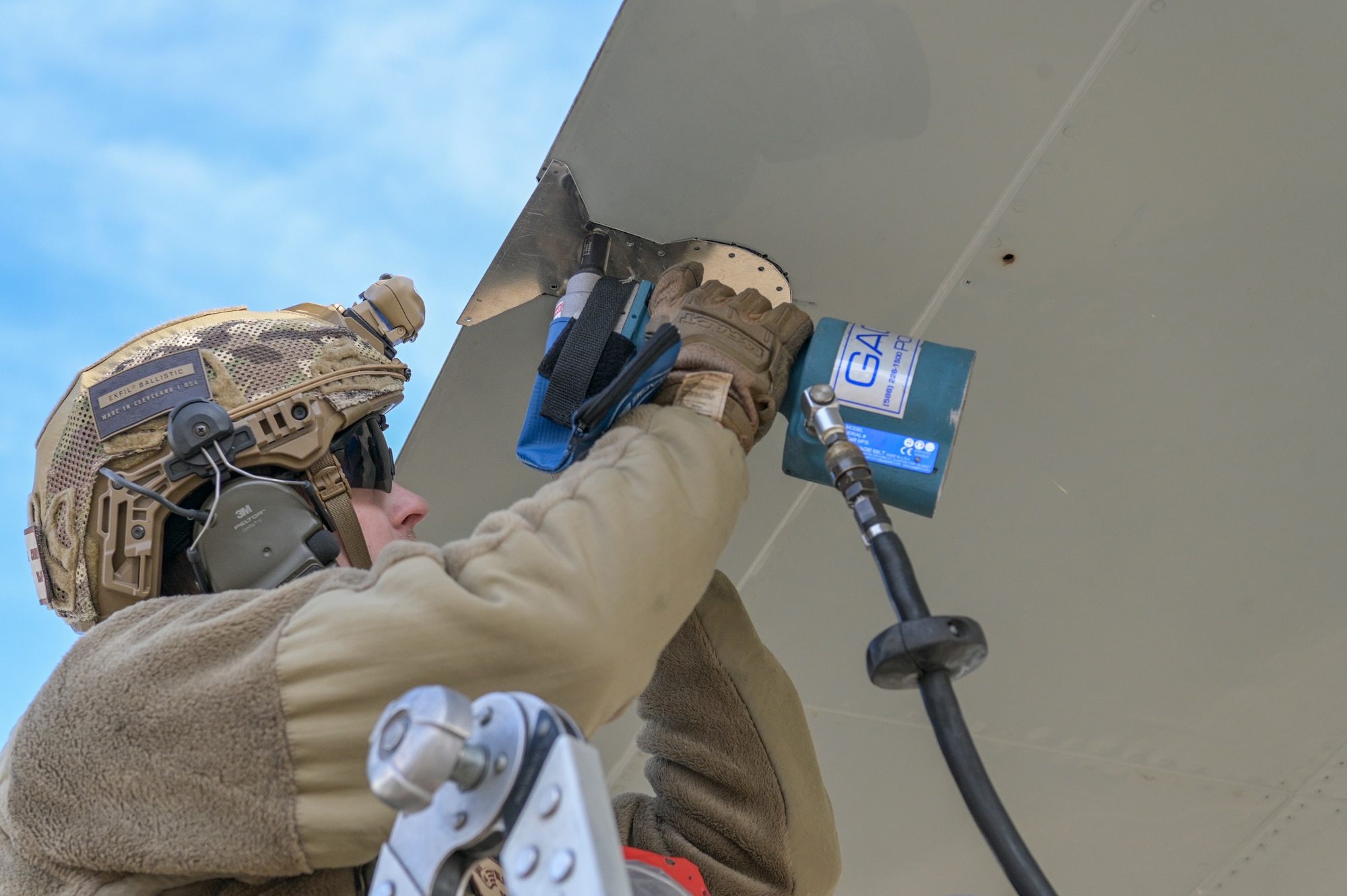 Man fixing aircraft wing
