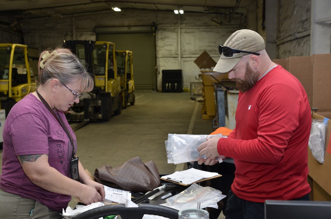 woman and man each inspecting items