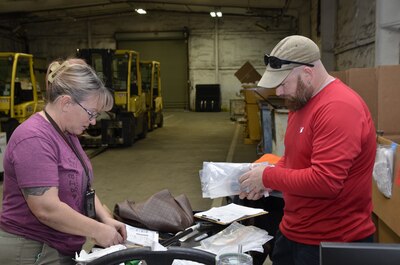 woman and man each inspecting items
