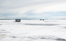 Ice fishing shacks sit on the ice at Devils Lake, North Dakota, Feb. 25, 2025. These shacks provide shelter and warmth to ice fishermen during the ice fishing season in North Dakota, where temperatures are consistently below zero. (U.S. Air Force photo by Senior Airman Kyle Wilson)