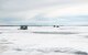 Ice fishing shacks sit on the ice at Devils Lake, North Dakota, Feb. 25, 2025. These shacks provide shelter and warmth to ice fishermen during the ice fishing season in North Dakota, where temperatures are consistently below zero. (U.S. Air Force photo by Senior Airman Kyle Wilson)