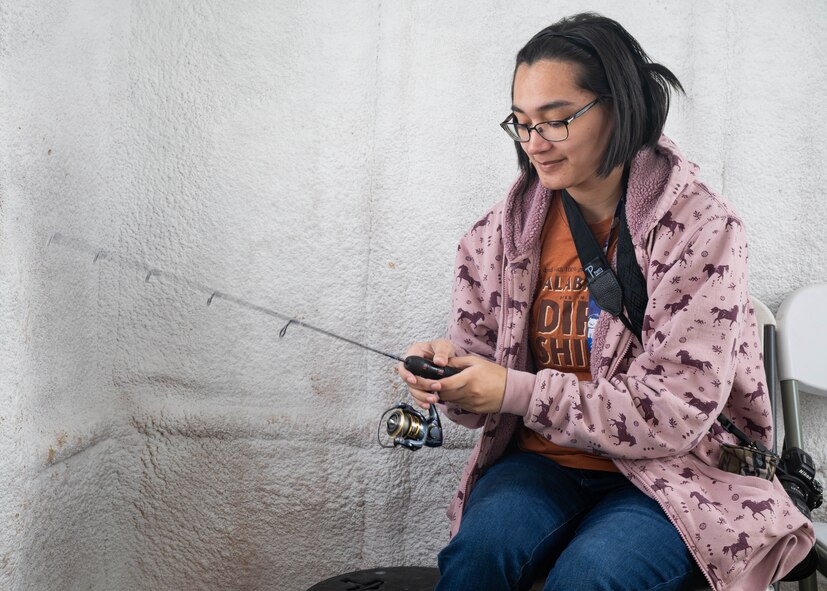 Senior Airman Kendra A. Ransum, 5th Bomb Wing public affairs specialist, ice fishes on Devils Lake, North Dakota, Feb. 25, 2025. Ransum fished on occasion previously, but this was her first time ice fishing. (U.S. Air Force photo by Senior Airman Kyle Wilson)