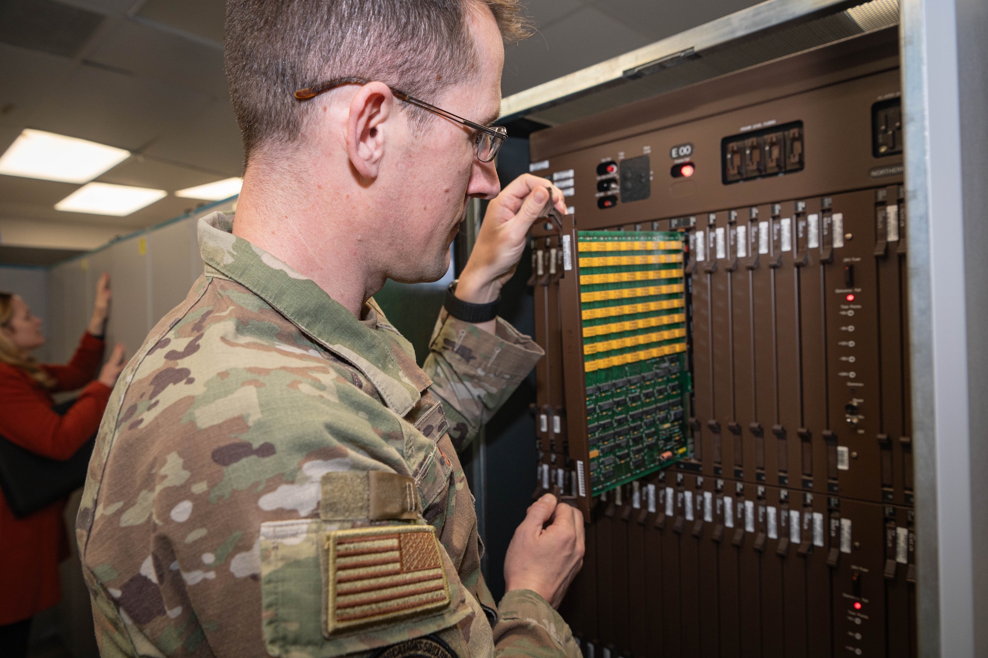 Lt. Col. Mike Scott, 55th Communications Squadron commander, pulls a circuit board from one of the racks of the Meridian Stored Logic 100 telephone switch Feb. 26, 2025. The MSL-100 was decommissioned after providing continuous service for more than 35 years. (U.S. Air Force photo by Daniel Martinez)