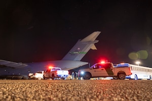 U.S. Airmen and U.S. Customs and Border Protection Agency personnel prepare to load illegal aliens onto a C-17 Globemaster III at Tucson International Airport in Tucson, Ariz., Jan. 23, 2025. Under the direction of U.S. Northern Command, U.S. Transportation Command is supporting Immigration and Customs Enforcement removal flights by providing military airlift.