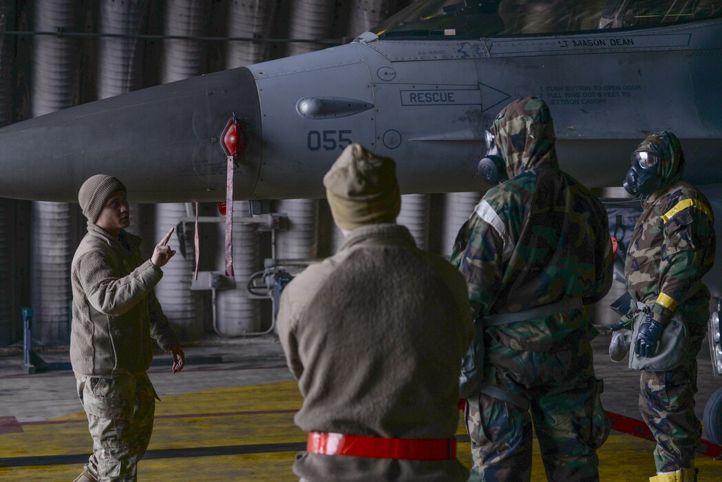 U.S. Air Force Tech. Sgt. Gerald Cruz, 36th Fighter Generation Squadron specialist flight Airman, delivers aircraft decontamination instructions to Airmen assigned to the 51st Maintenance Group at Osan Air Base, Republic of Korea, Feb. 28, 2025. The instructional and hands-on training allowed the 51st MXG to hone their contingency response capabilities by decreasing the time it takes to decontaminate personnel and aircraft in the event of a chemical, biological, radiological, or nuclear exposure. (U.S. Air Force photo by Staff Sgt. Kahdija Slaughter)