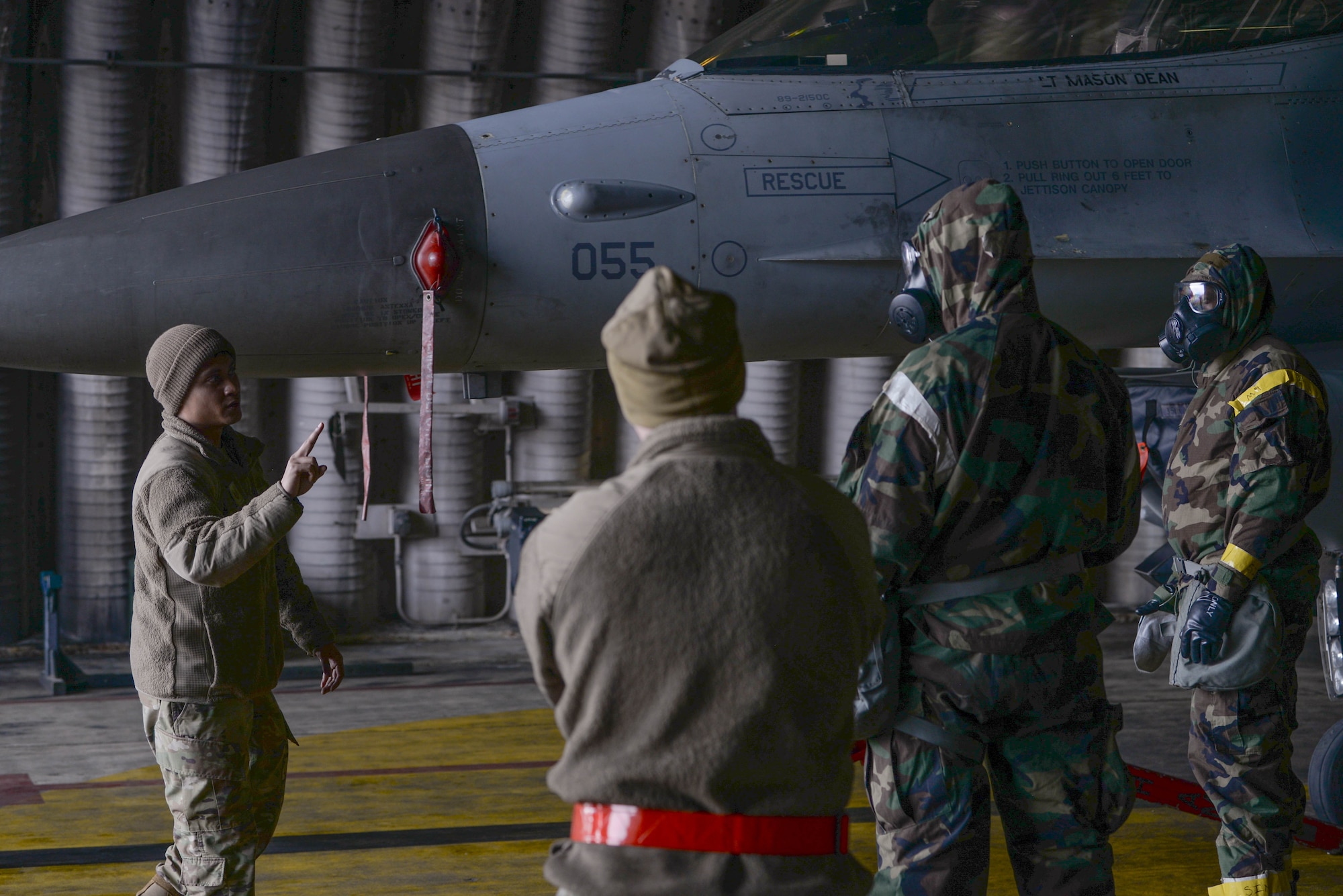U.S. Air Force Tech. Sgt. Gerald Cruz, 36th Fighter Generation Squadron specialist flight Airman, delivers aircraft decontamination instructions to Airmen assigned to the 51st Maintenance Group at Osan Air Base, Republic of Korea, Feb. 28, 2025. The instructional and hands-on training allowed the 51st MXG to hone their contingency response capabilities by decreasing the time it takes to decontaminate personnel and aircraft in the event of a chemical, biological, radiological, or nuclear exposure. (U.S. Air Force photo by Staff Sgt. Kahdija Slaughter)