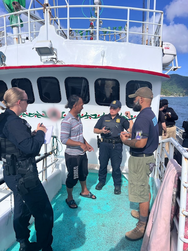 A U.S. Coast Guardsman assigned to a Coast Guard Sector Honolulu boarding team, National Oceanic and Atmospheric Administration Office of Law Enforcement officer and American Samoa Department of Marine and Wildlife Resources officer speak to the master of a foreign-flagged fishing vessel during a boarding offshore Pago Pago, American Samoa, Feb. 26, 2025. While deployed to American Samoa, Coast Guard personnel boarded six U.S.-flagged commercial fishing vessels and six foreign-flagged commercial fishing vessels. (U.S. Coast Guard photo, courtesy Sector Honolulu)