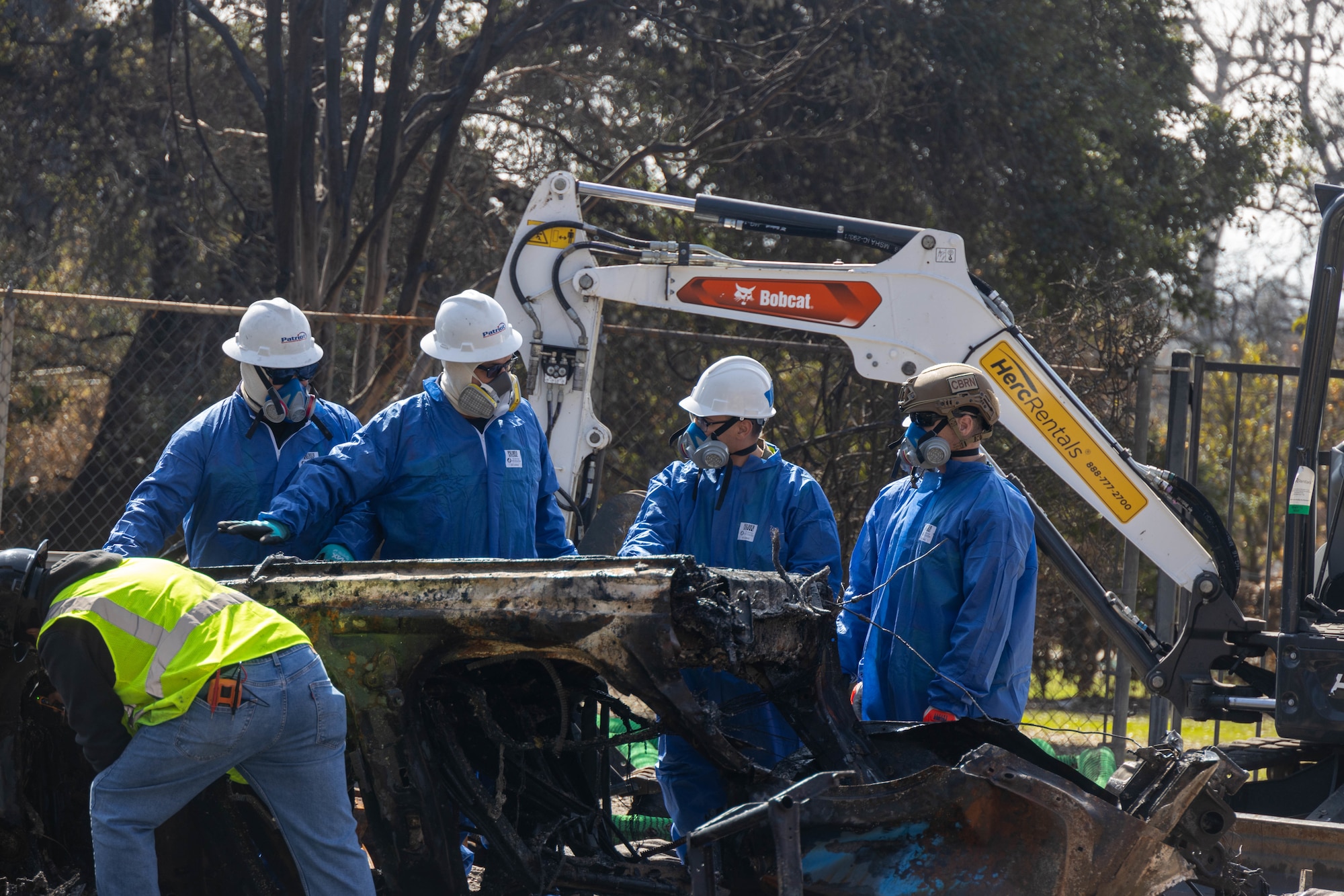 Tech. Sgt. Christopher Mathis (far right), 775th Civil Engineer Squadron, assists with clean up efforts in the aftermath of the California wildfires. Guzman spent two weeks primarily removing batteries from electric vehicles and burned residences with power walls for solar panels. (Courtesy Photo)