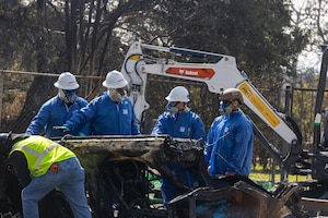 Tech. Sgt. Christopher Mathis (far right), 775th Civil Engineer Squadron, assists with clean up efforts in the aftermath of the California wildfires. Guzman spent two weeks primarily removing batteries from electric vehicles and burned residences with power walls for solar panels. (Courtesy Photo)