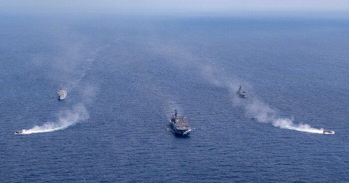 The forward-deployed amphibious assault ship, USS America (LHA 6), center, steams in formation with the amphibious dock landing ship USS Rushmore (LSD 47), second from left, the Japan Maritime Self-Defense Force (JMSDF) tank landing ship JS Kunisaki (LST-4003), second from right, and two JMSDF landing craft during Exercise Iron Fist in the Philippine Sea, Feb. 28.