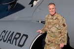 a man stands by an aircraft