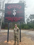 a man stands in front of a sign