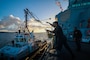 Operations Specialist 3rd Class Kevin Figueroa-Rodrigues throws a heaving line to the tug boat during a Sea and Anchor evolution aboard the Arleigh Burke-class guided-missile destroyer USS Bulkeley (DDG 84), as the ship arrives to Souda Bay, Greece, Nov. 18, 2024.