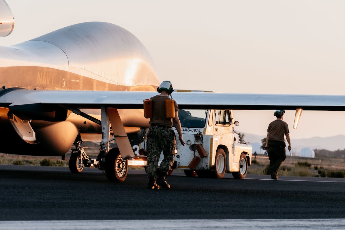 Sailors assigned to Unmanned Patrol Squadron (VUP) 19, tow an MQ-4C Triton at Naval Air Station (NAS) Sigonella, Italy, Jul. 2, 2024