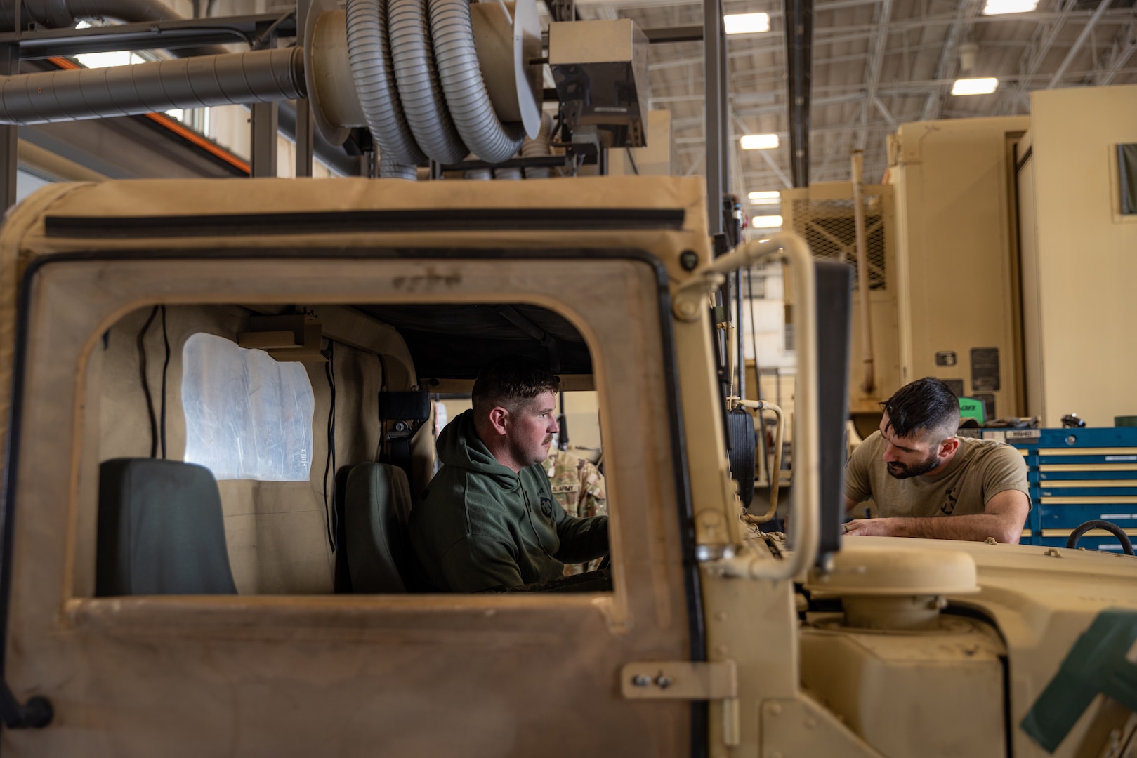 Oklahoma Army National Guard Soldiers Sgt. Gunnar Pike (left), and Sgt. David Quinn (right), mechanics with a team from Field Maintenance Shop Two, inspect a Humvee during the Mechanic of the Year competition held at the Combined Support Maintenance Shop in Norman, Oklahoma, Feb. 26, 2025. The Guardsmen came together for the fourth annual competition, teaming up to showcase their mechanic skills and connect with fellow competitors.(Oklahoma National Guard photo by Spc. Danielle Rayon)