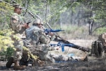 An exercise cadre monitors Airmen protecting an injured member during a field training exercise at Joint Base Pearl Harbor-Hickam, Hawaii, Feb. 2, 2025. The exercise tested the Airmen's tactical abilities and emphasized the importance of mental resilience and decision-making under pressure.