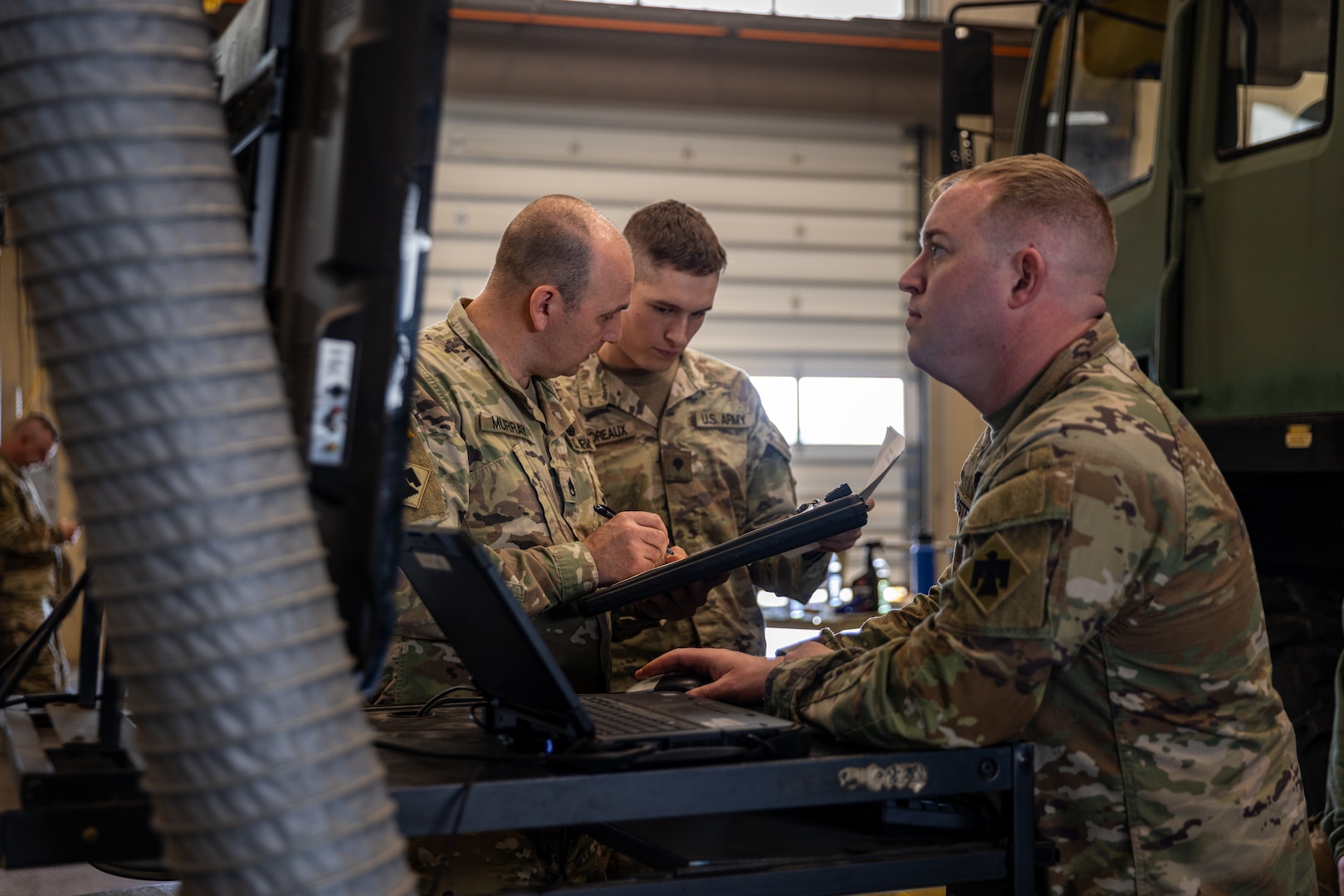 (From left to right) Oklahoma Army National Guard Soldiers Staff Sgt. Royal Murray, senior mechanic, Spc. Luke Lamareaux, mechanic, and Staff Sgt. Tyler Foster, senior mechanic, a team from Field Maintenance Shop Six, inspect a Light Medium Tactical Vehicle during the Mechanic of the Year competition held at the Combined Support Maintenance Shop in Norman, Oklahoma, Feb. 26, 2025. The Guardsmen came together for the fourth annual competition, teaming up to showcase their mechanic skills and connect with fellow competitors.(Oklahoma National Guard photo by Spc. Danielle Rayon)