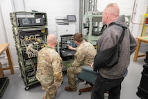 Photo of depot employees training Soldiers on the CPN system