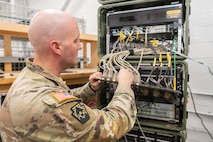 Photo of a Soldier working on a CPN system