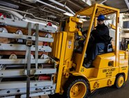 Aviation Ordnanceman 2nd Class Richard Fredette, from Bristol, Tennessee, assigned to the Wasp-class amphibious assault ship USS Iwo Jima (LHD 7) lifts ammo while operating a forklift during the ship’s ammunition onload while moored at Naval Weapons Station Earle.
