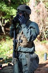 soldier in gas mask and CBRN protective suit