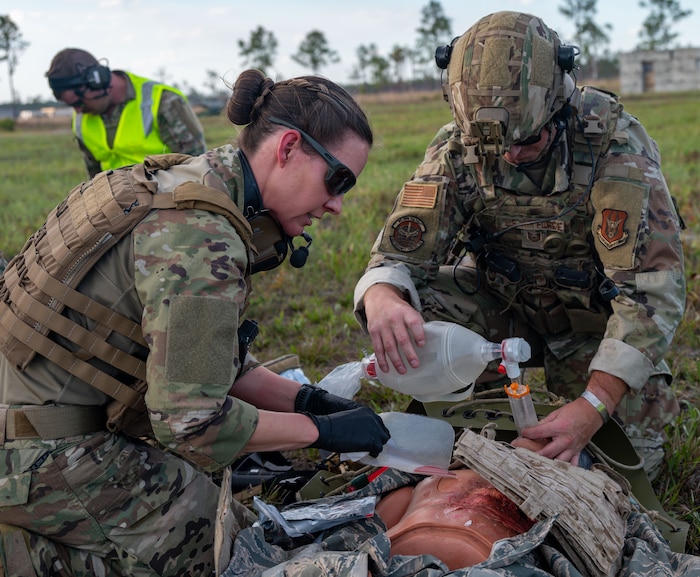 Maj. Danielle Humphrey, 920th Rescue Wing Tactical Medical Augmentation Team concept lead nurse, and Tech. Sgt. Kyle Wheeler, 920th Security Forces Squadron fire team leader, performed critical care on a patient during a simulated medical evacuation at Avon Park Auxiliary Airfield, Feb. 26, 2025. Citizen Airmen from the 920th ASTS, alongside joint and international partners, honed their medical and patient evacuation skills during MEDBEACH 2025, a hands-on training exercise reinforcing en route patient staging capabilities and wartime medical operations. (U.S. Air Force photo by Tech. Sgt. Darius Sostre-Miroir)