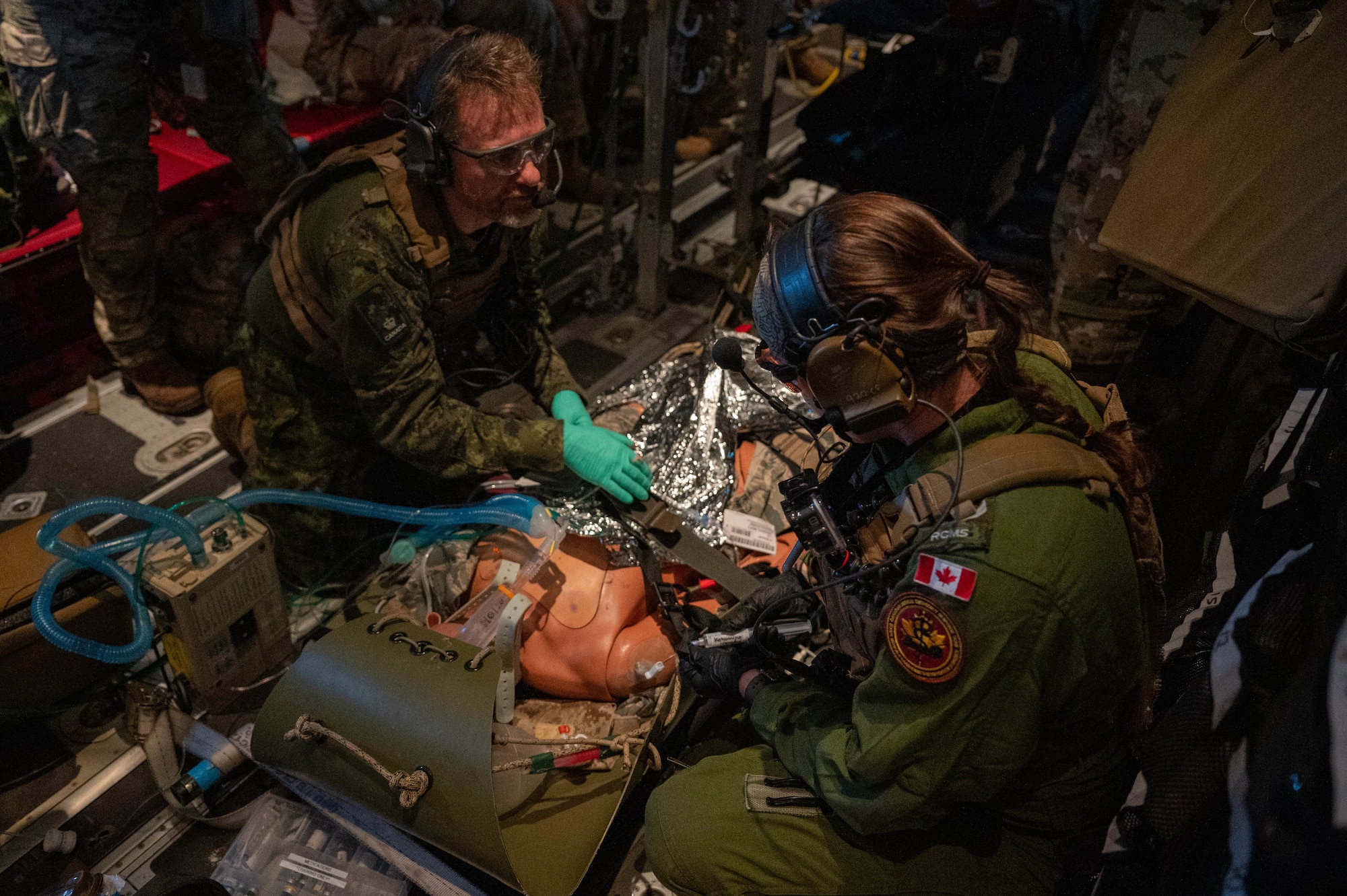 Members of the Canadian Armed Forces care for a patient onboard an HC-130J Combat King II aircraft en route to Avon Park, Fla., Feb 26, 2025. Citizen Airmen from the 920th Aeromedical Staging Squadron, alongside joint and international partners, honed their medical and patient evacuation skills during MEDBEACH 2025, a hands-on training exercise reinforcing en route patient staging capabilities and wartime medical operations. (U.S. Air Force photo by Tech. Sgt. Kristen Pittman)