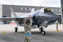 An aircraft maintainer assigned to the Florida Air National Guard's 125th Maintenance Group marshals an F-35A Lightning II aircraft arriving at the wing in Jacksonville, Florida, March 4, 2025. The arrival marks the unit’s transition to the fifth-generation fighter aircraft, enhancing the wing’s 24/7 homeland defense mission and strengthening joint-force integration efforts in Florida.