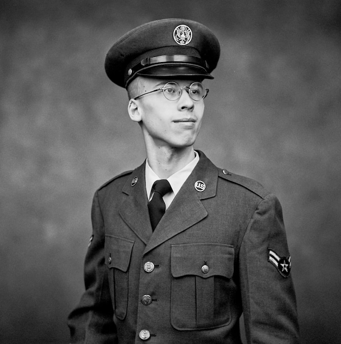 A young Airman poses for a black and white film photo wearing a vintage service dress uniform