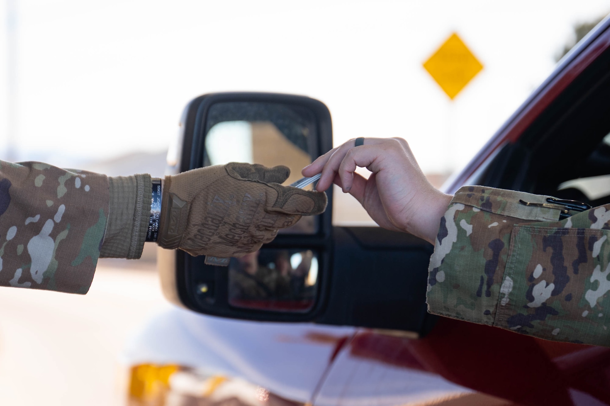 Uniformed personnel perform gate guard duties.