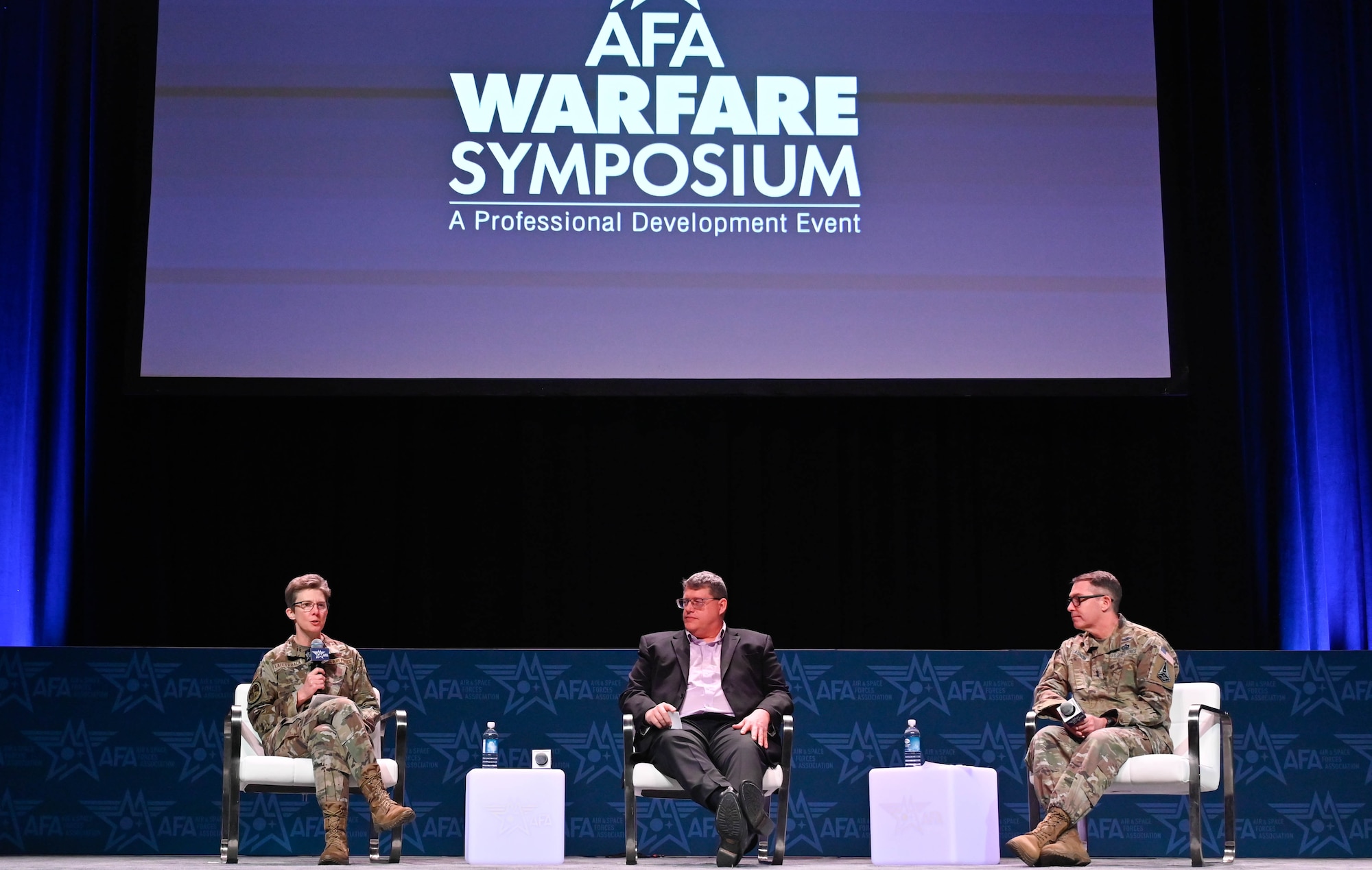 Air Force and Space Force leaders sit on a panel.