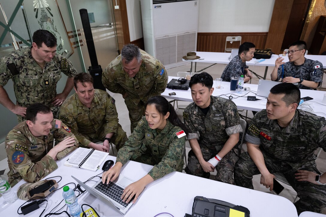 Joint multinational space component command members from the U.S., Australia, Singapore, and South Korea review data points in Camp Suranaree, Thailand, Feb. 26, 2025, during Exercise Cobra Gold.