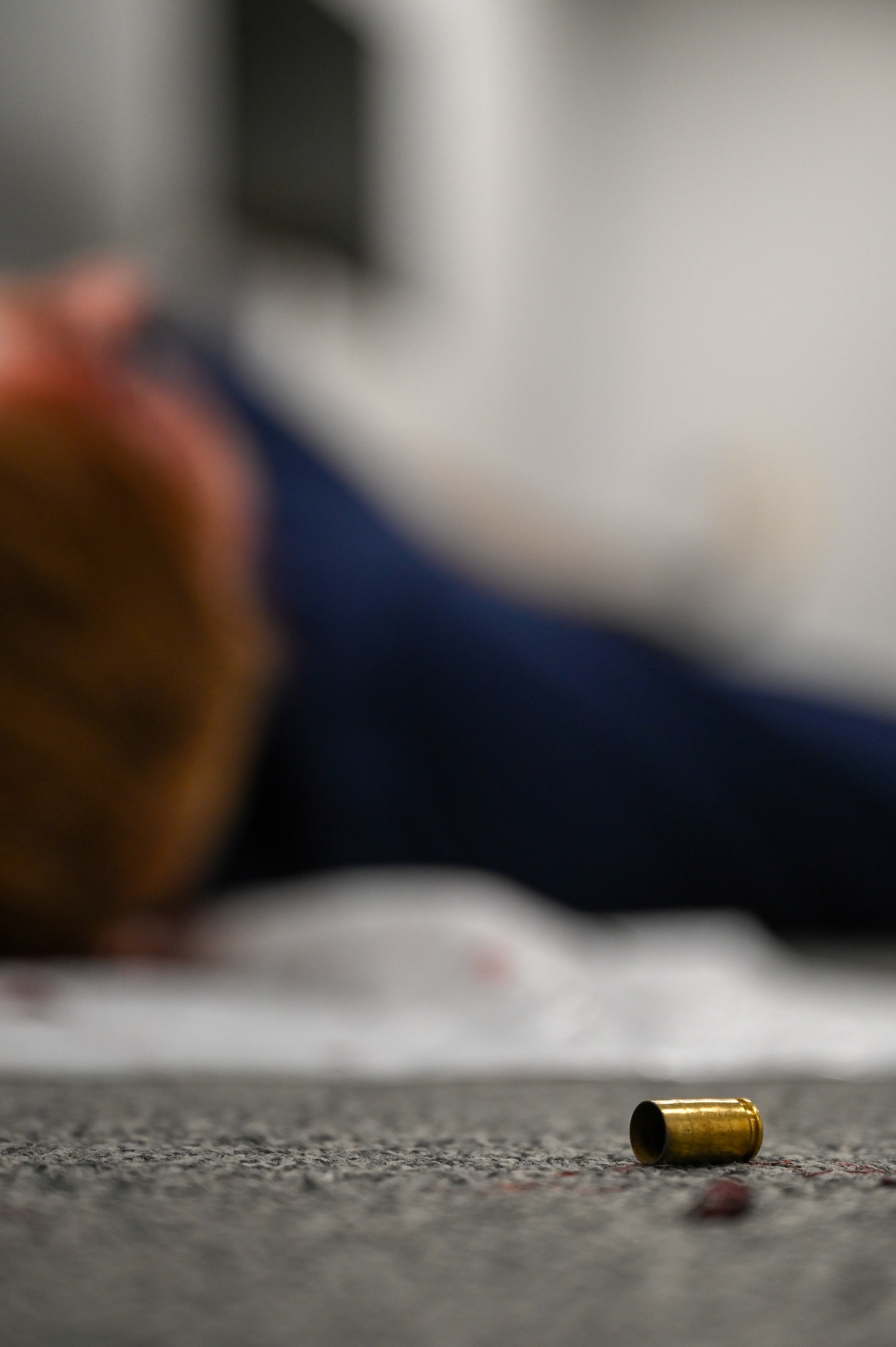 Uniformed personnel provide aid and security to simulated victims of a simulated active shooter.