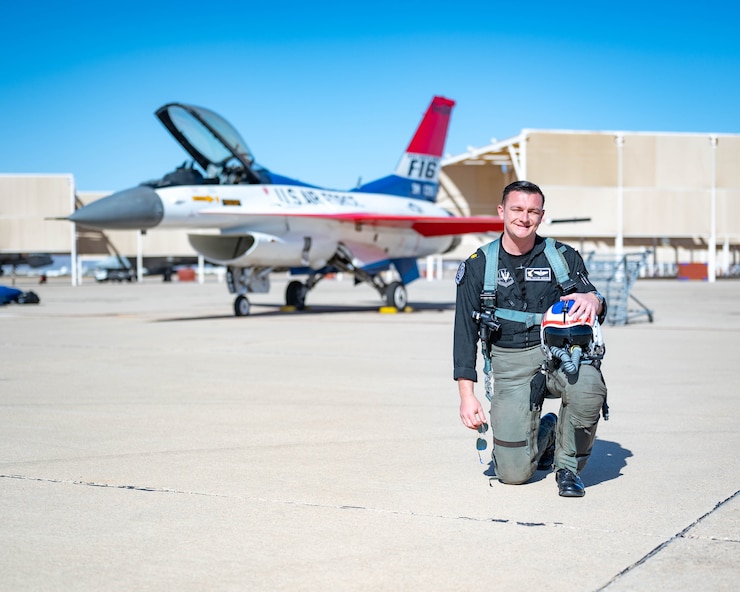 A photo of a pilot in front of an F-16 Fighting Falcon.