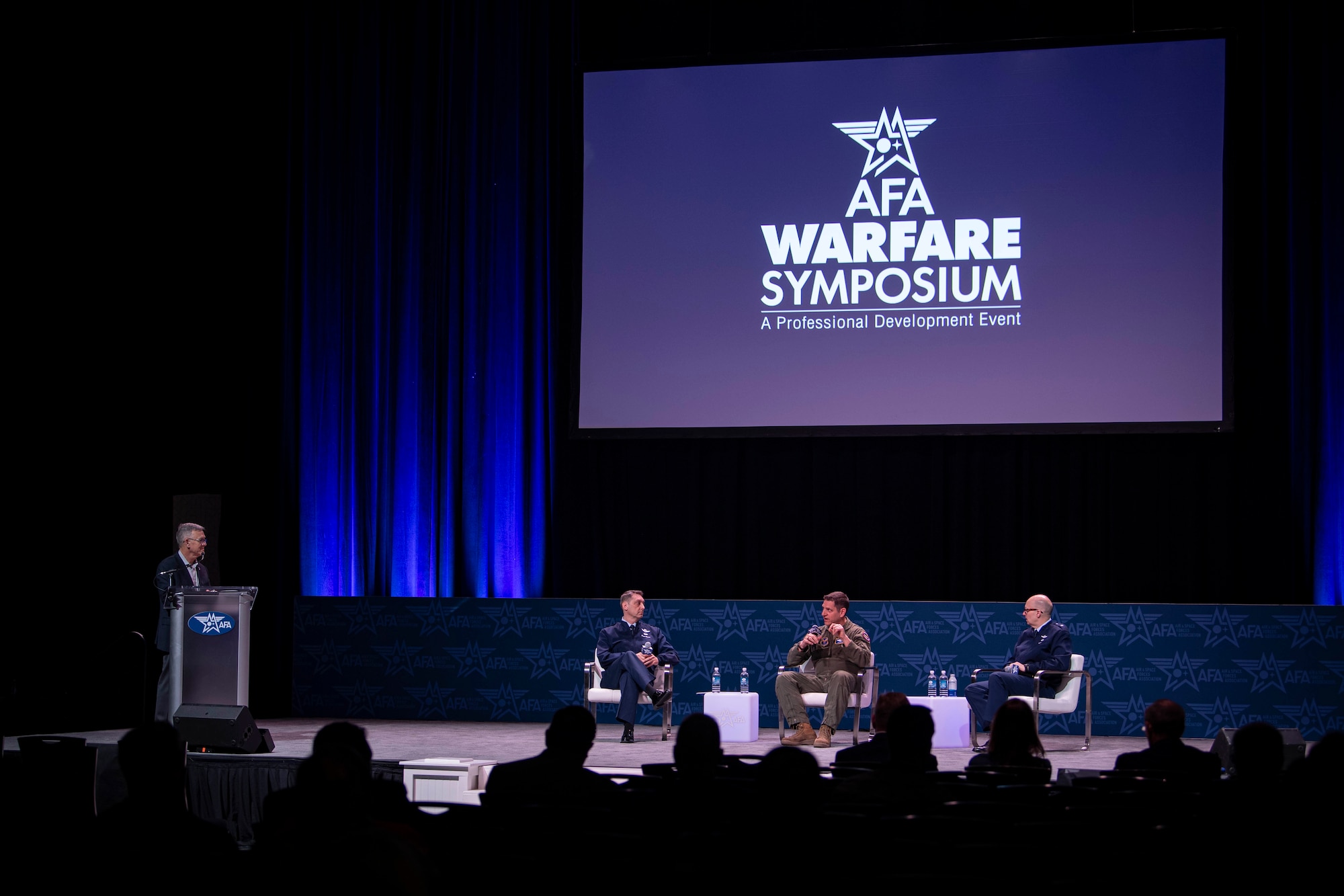 Lt. Gen. Dave Harris, deputy chief of staff for Air Force Futures, Maj. Gen Joseph Kunkel, the director of Force Design, Integration, and Wargaming, and Brig. Gen. Ryan Keeney, the director, Concepts and Strategy, Deputy Chief of Staff, Air Force Futures, speak at the Air and Space Forces Association Warfare Symposium in Aurora, Colo., March 4, 2025. (U.S. Air Force photo by Staff Sgt. Adam R. Shanks)