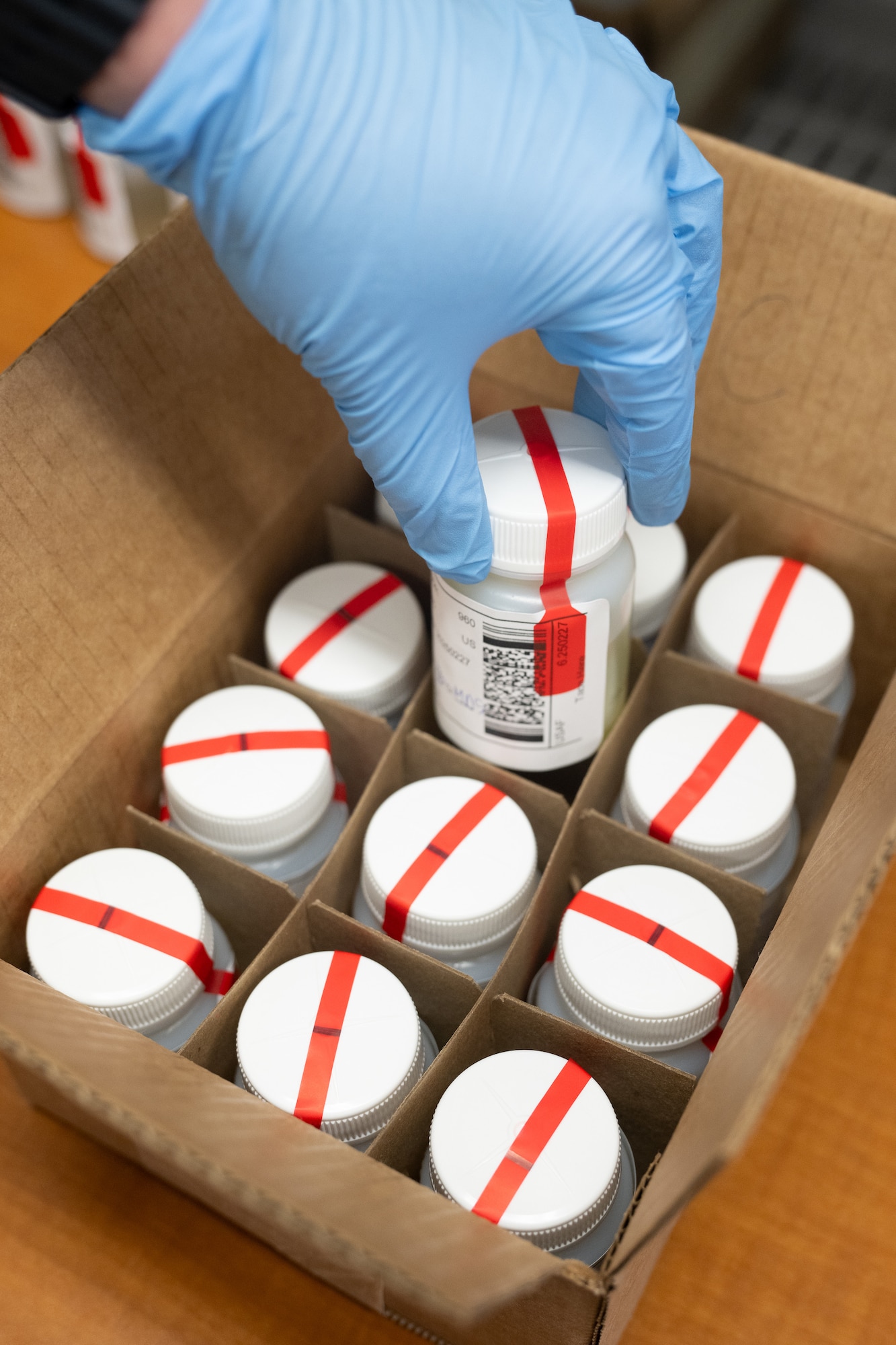 Abbey Hill, 436th Airlift Wing Drug Demand Reduction Program manager, conducts a quality assurance inspection on urine samples during a random drug screening at Dover Air Force Base, Delaware, Feb. 27, 2025. The DDRP staff administers between 270 to 315 drug tests each month. (U.S. Air Force photo by Mauricio Campino)