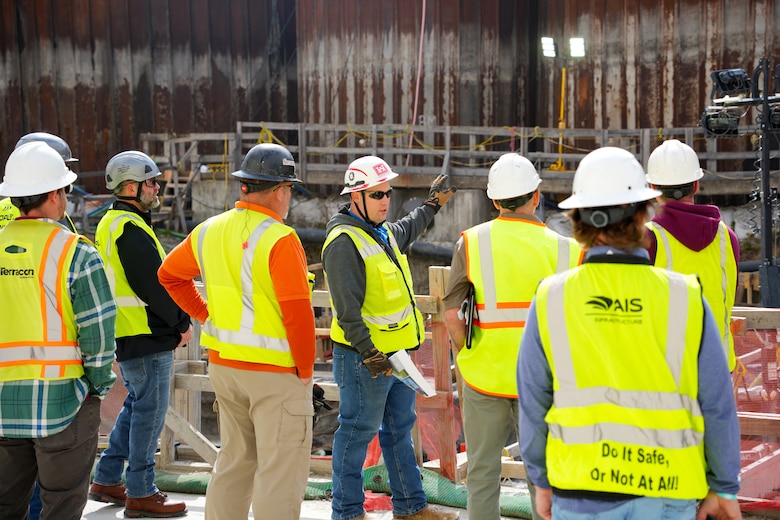 Allen Malcomb, Chickamauga Lock Replacement Project chief of quality assurance, points out sections of the coffer dam during a pre-proposal site visit, March 4, 2025, in Chattanooga, Tennessee.