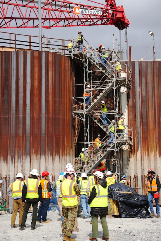 Contractors and subcontractors climb the scaffolding stairs to the top of the coffer dam during a tour of the Chickamauga Lock Replacement Project, March 4, 2025, at Chickamauga Lock in Chattanooga, Tennessee.