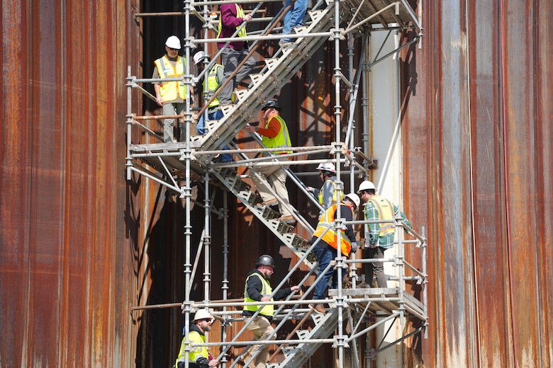 Contractors and subcontractors climb the scaffolding stairs to the top of the coffer dam during a tour of the Chickamauga Lock Replacement Project, March 4, 2025, at Chickamauga Lock in Chattanooga, Tennessee.