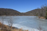 Marquette Lake at Fort Indiantown Gap was still covered with ice when this photo was taken on March 3, 2025. The lake will soon be drained as part of a construction project to replace the dam. (Pennsylvania National Guard photo by Brad Rhen)