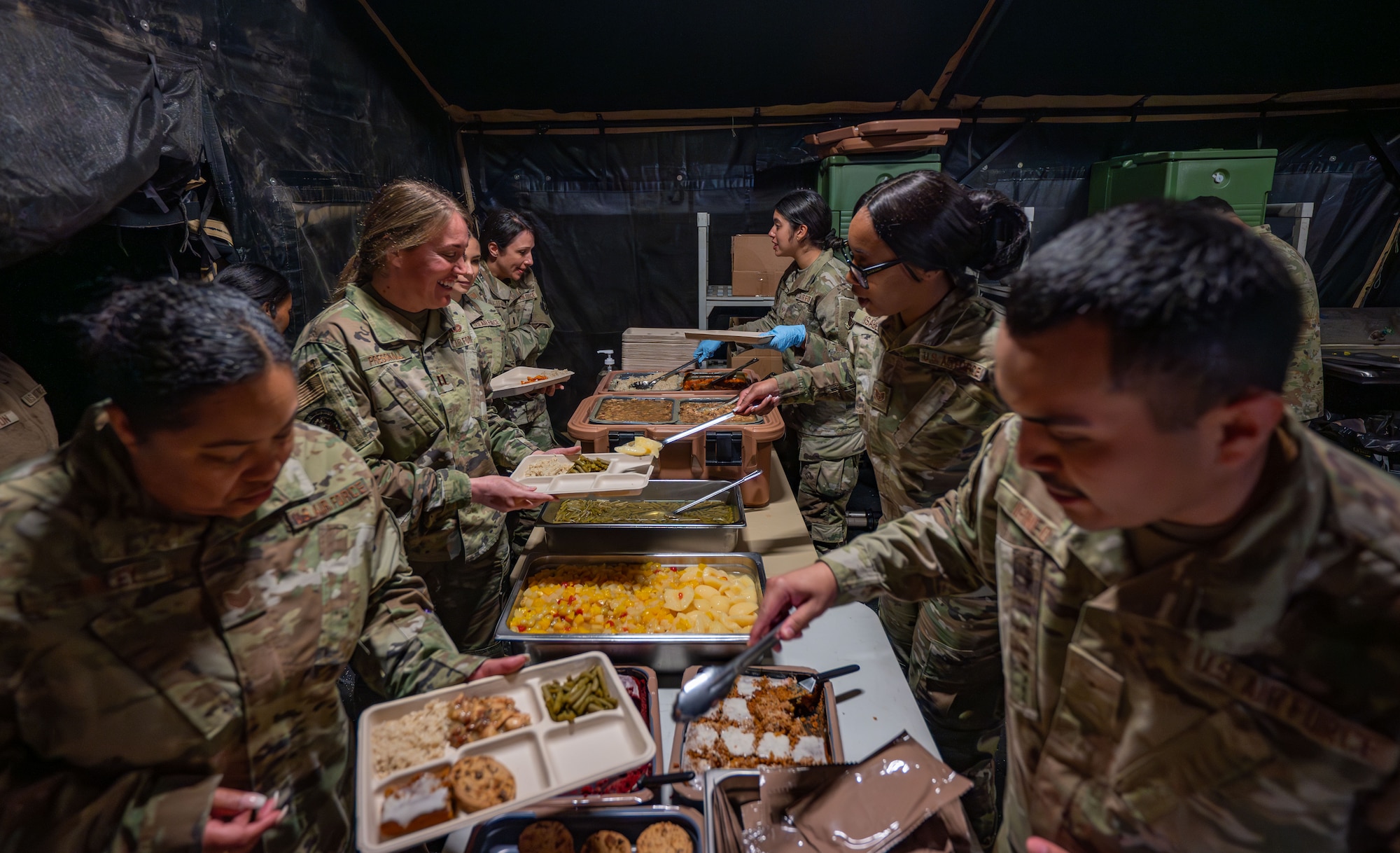 Airmen assigned to the 920th Force Support Squadron served a hot meal from inside the Single Pallet Expeditionary Kitchen during MEDBEACH 2025 at Avon Park Auxiliary Field, Florida, Feb. 25, 2025. Citizen Airmen from the 920th Aeromedical Staging Squadron, alongside joint partners, honed their medical and patient evacuation skills during hands-on training, reinforcing en route patient staging capabilities and wartime medical operations. (U.S. Air Force photo by Tech. Sgt. Darius Sostre-Miroir)