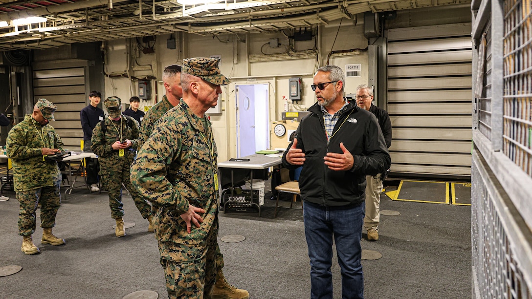 U.S. Marine Corps Brig. Gen. Kevin Collins, commanding general, 3rd Marine Logistics Group, receives a capabilities brief on maritime prepositioning force assets from Samuel Paulk, assistant officer in charge of the technical assistance and advisory team, Feb. 27 during Freedom Banner 25 at the Chinhae Naval Ammunition Pier, Republic of Korea Naval Base Chinhae, South Korea. (Official U.S. Marine Corps Photo/Cpl. Nicholas Martinez)