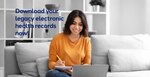 Smiling young woman in orange shirt sits on couch and looks at laptop. Text reads, "Download your legacy electronic health records now!"