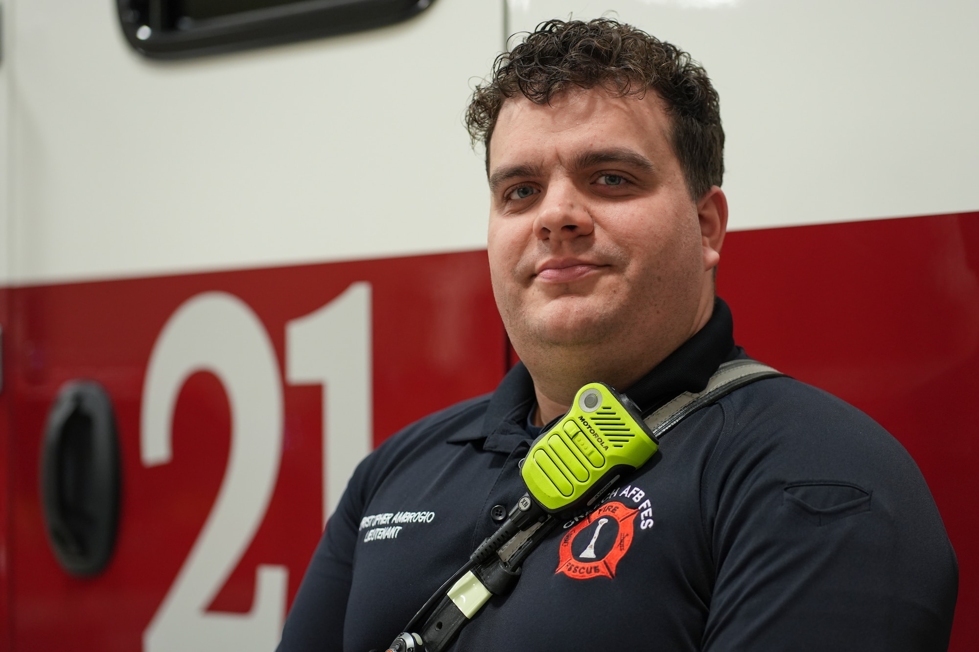 A man stands in front a fire truck.