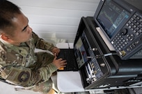 U.S. Air Force Senior Airman Irvin Magayanes, 150th Electronic Warfare Squadron, space operator, calibrates the Honey Badger system during Exercise Cobra Gold 2025 in Camp Suranaree, Thailand, Feb. 26, 2025.